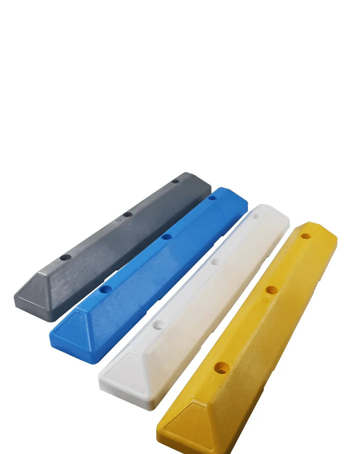 Set of four recycled plastic parking blocks in gray, blue, white, and yellow colors