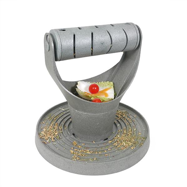 Image of a chicken treat dispenser, grey, with a roller ball on top, a place to put treats and a ridged base