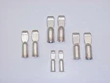 Assorted metal battery terminal tips for facility power systems on white background