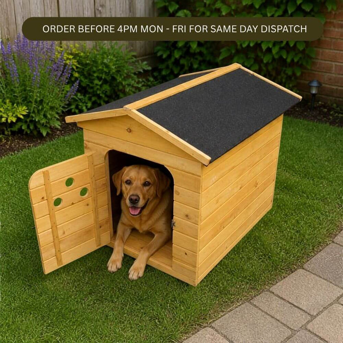 A golden retriever dog sits inside a wooden dog house with an open door, placed on a green lawn in a backyard. The dog house has a light natural wood exterior and a dark gray roof.